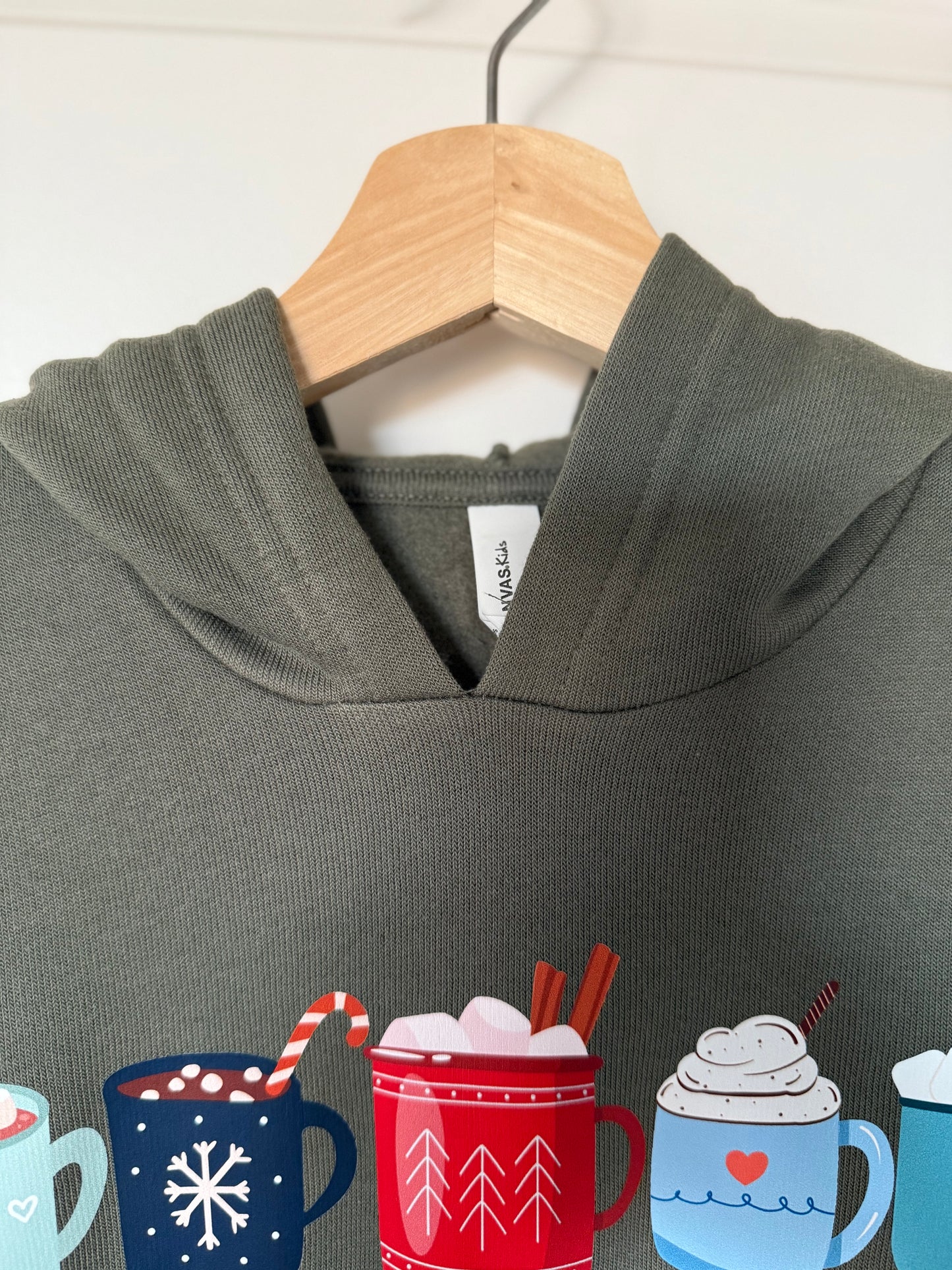 Gray hoodie with hot chocolate-themed mugs on a hanger