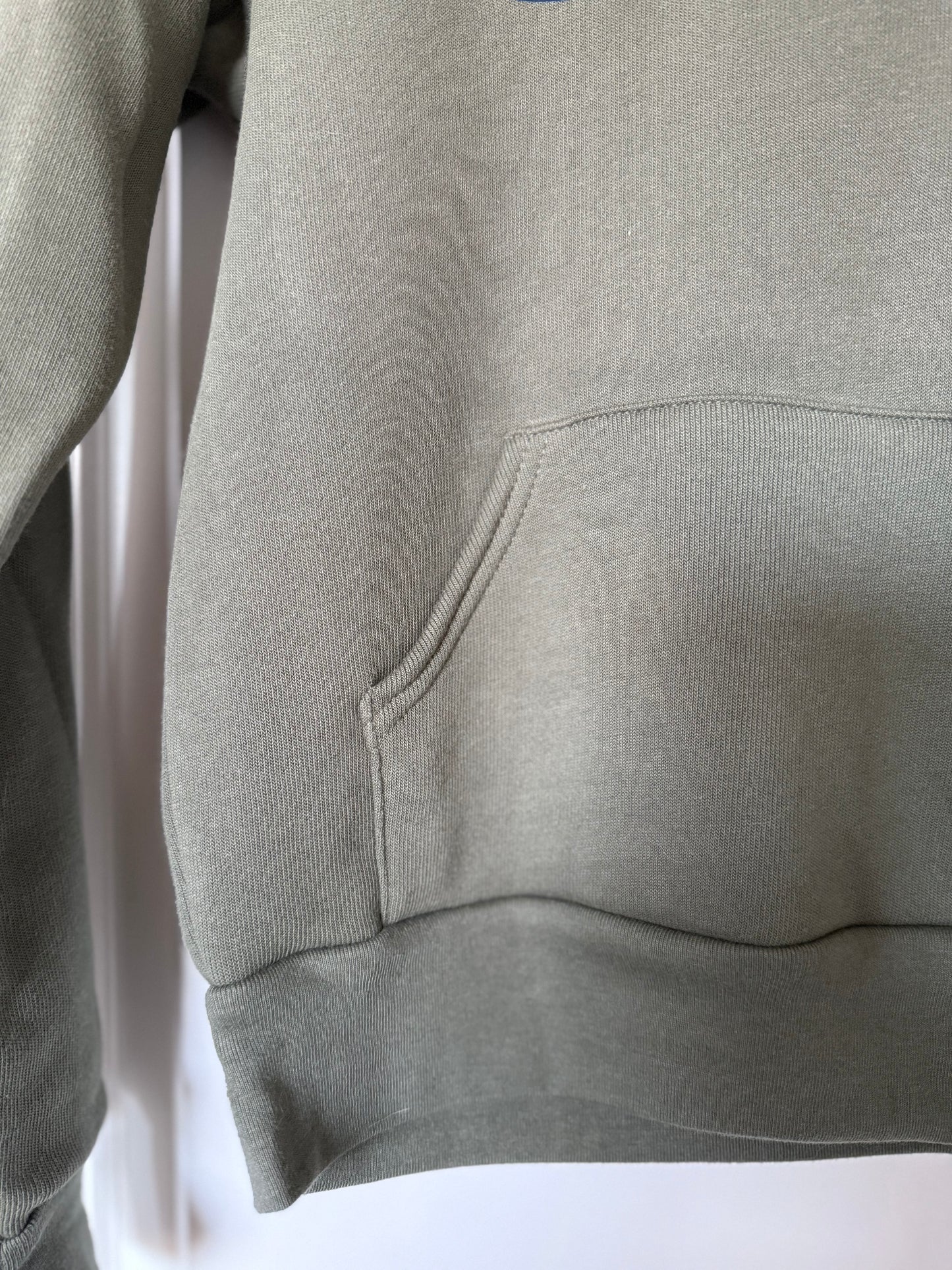 Green hoodie with a pocket on a white background