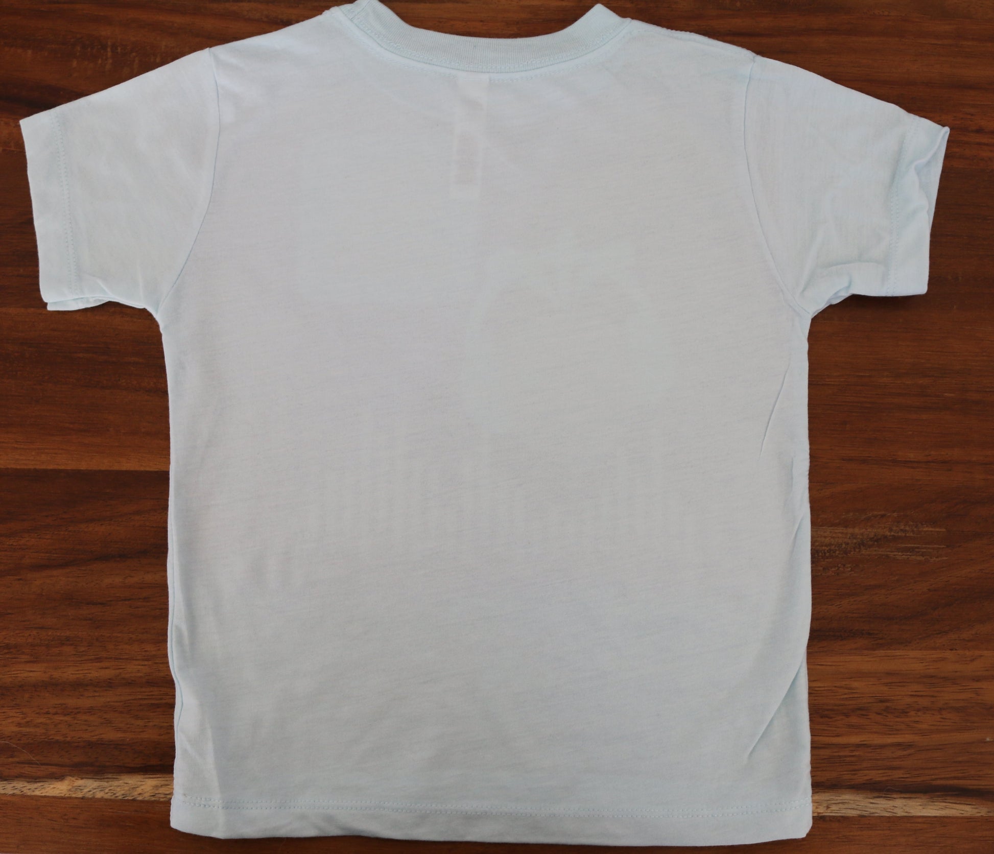 Light blue t-shirt on a wooden surface